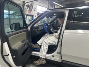 photo of a service tech in a rivian vehicle